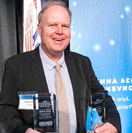 David Baker poses with IBA awards